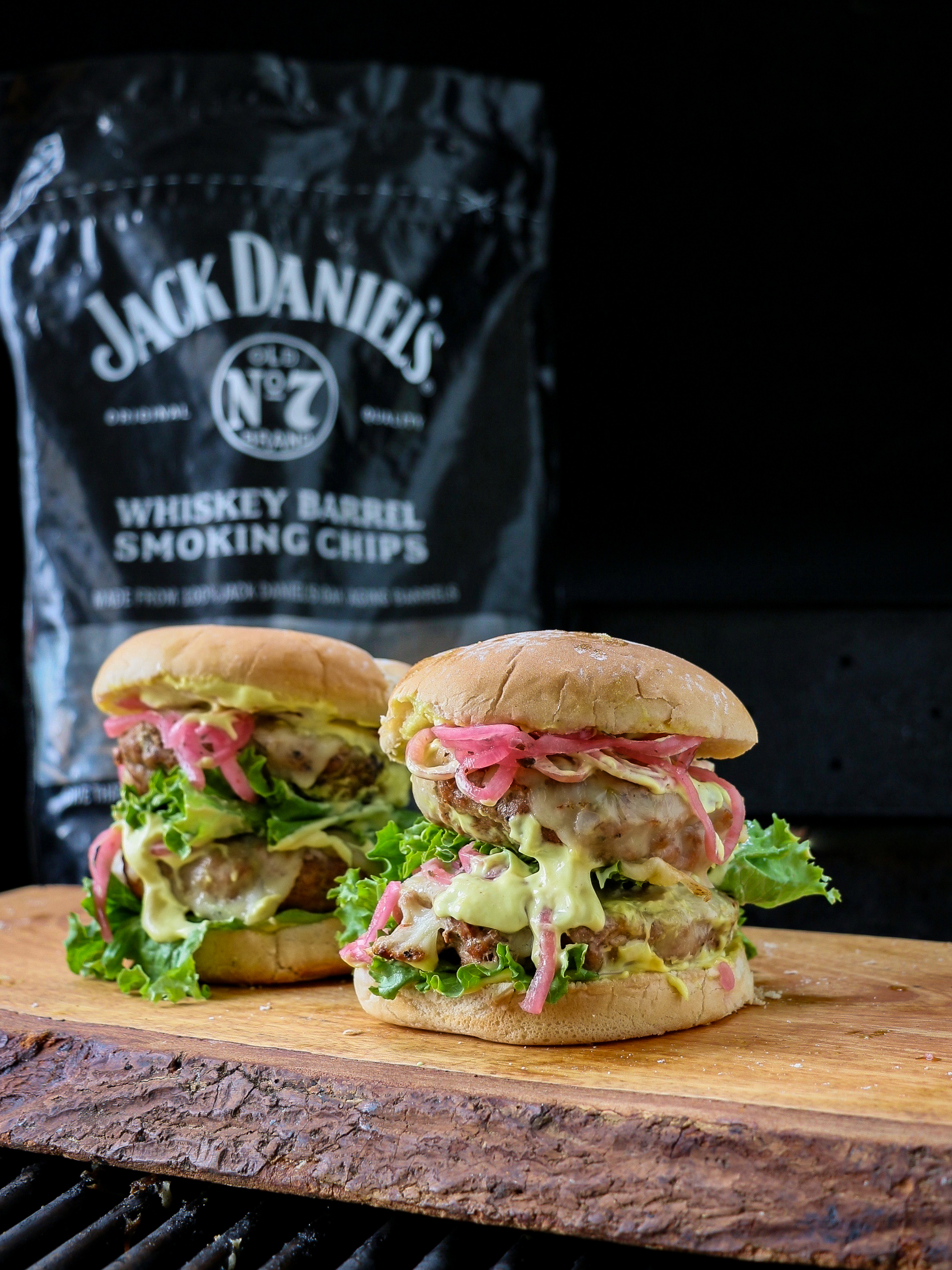 To show the deliciousness of a pork burger and pickled onions.