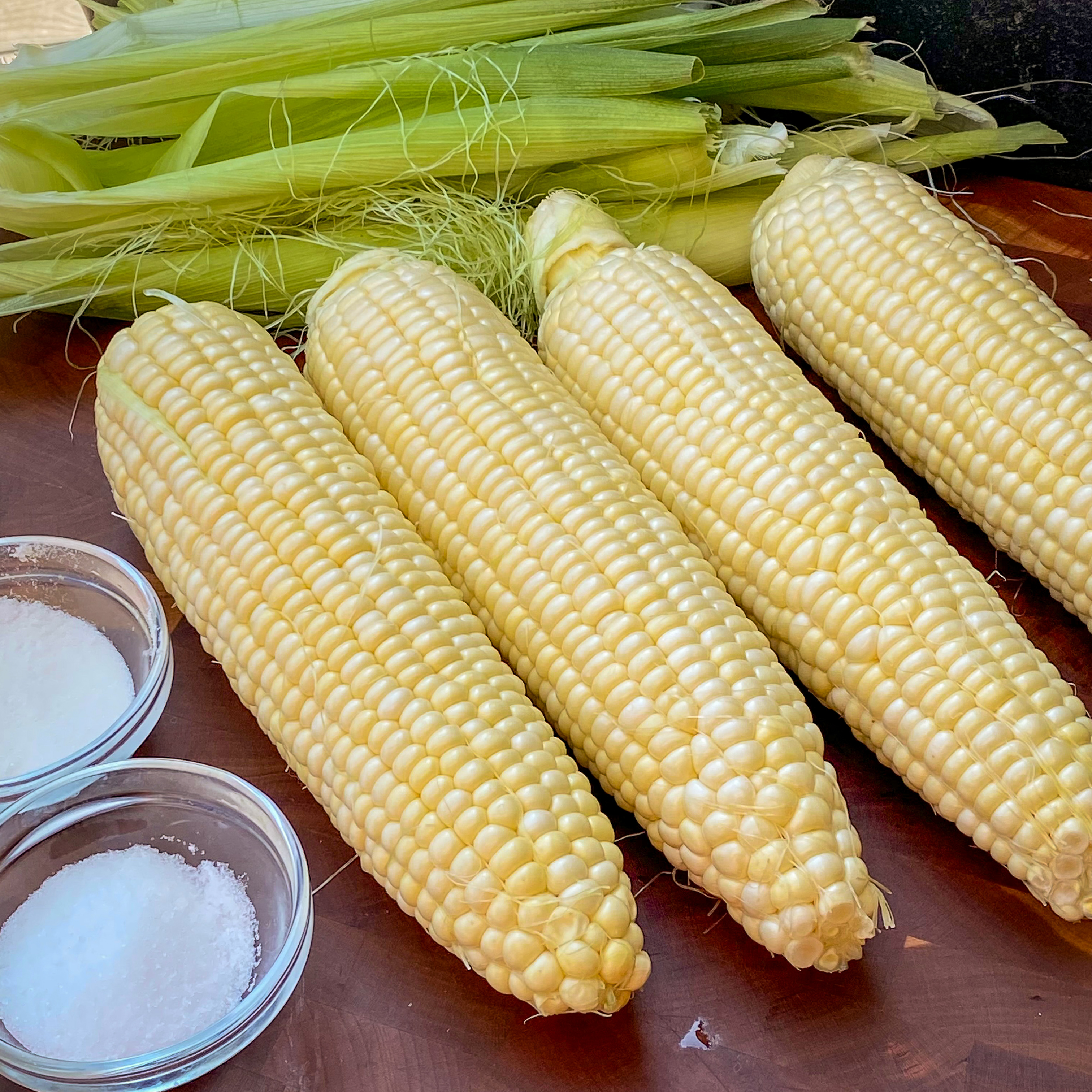 Add salt and sugar to a pot of boiling water to elevate the flavor of corn before grilling. 