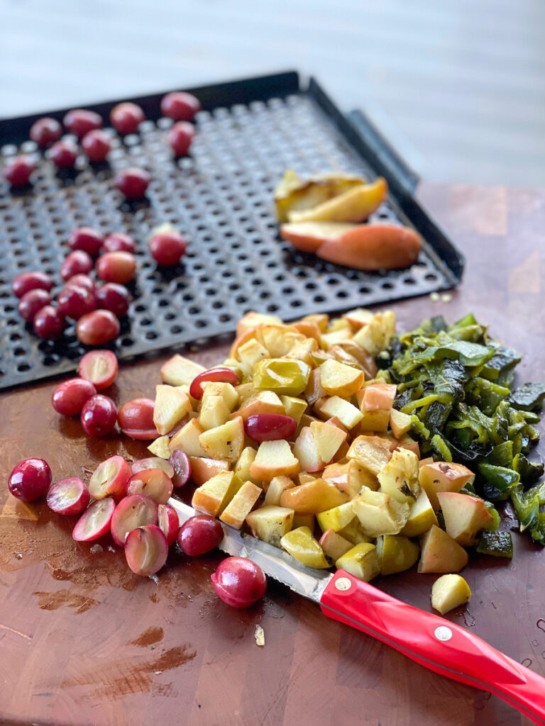 Grilled grapes and apples with charred poblano pepper will be chopped together for topping smoked meat.