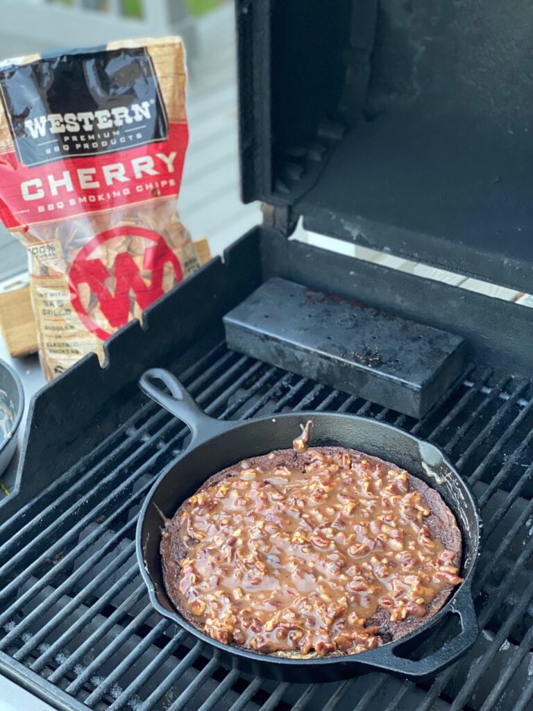 A bag of Western BBQ Smoking Chips and a skillet of caramel pecan bownies. 