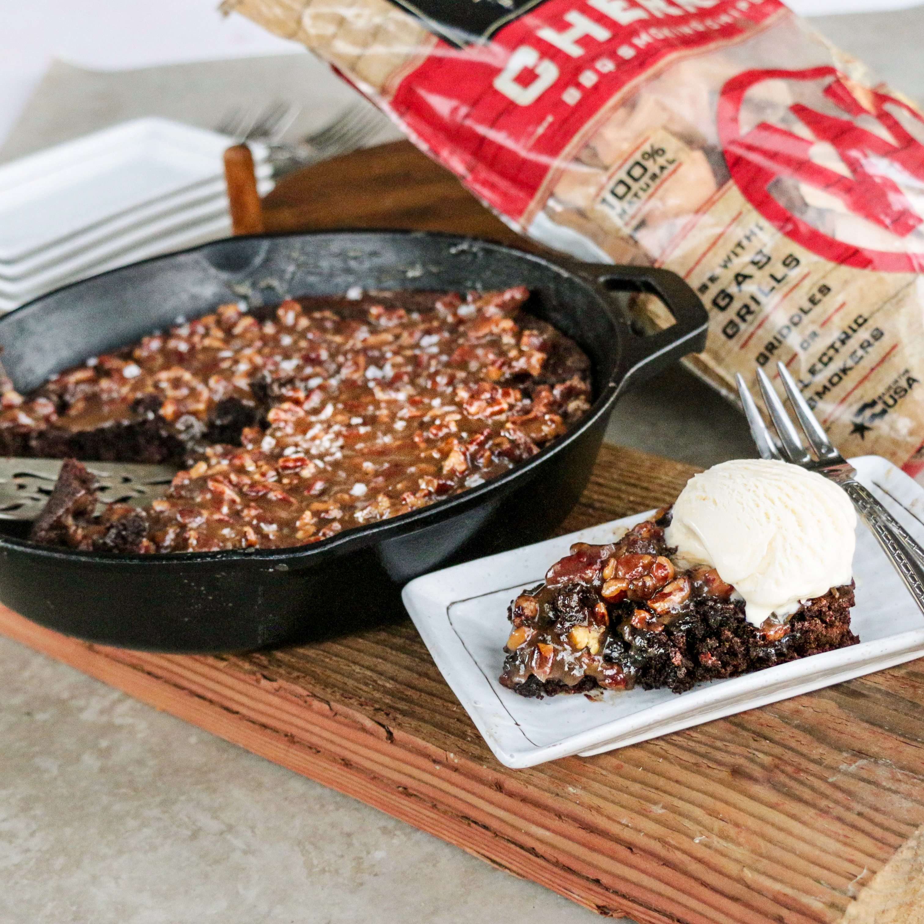 A slice of cherry smoked brownie with a caramel topping and ice cream. 