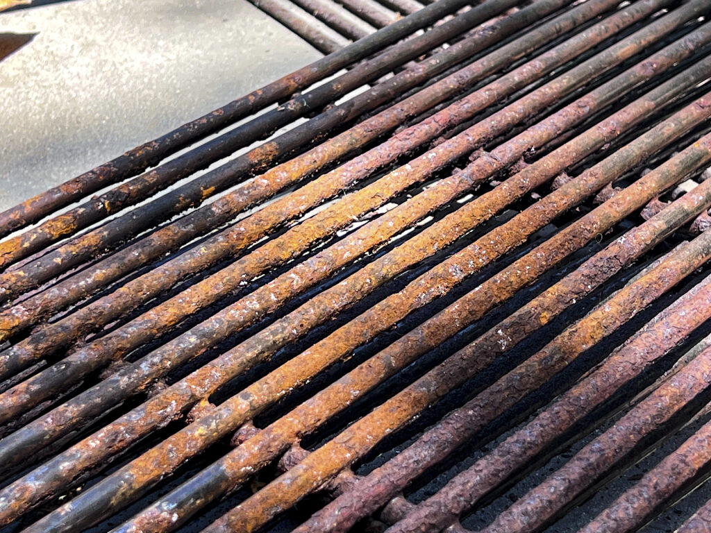 A close up of a very rusty grill grate.