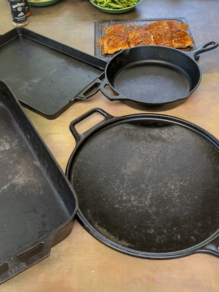 Showing 5 cast iron pieces of cookware that can substitute for plancha grill surface.