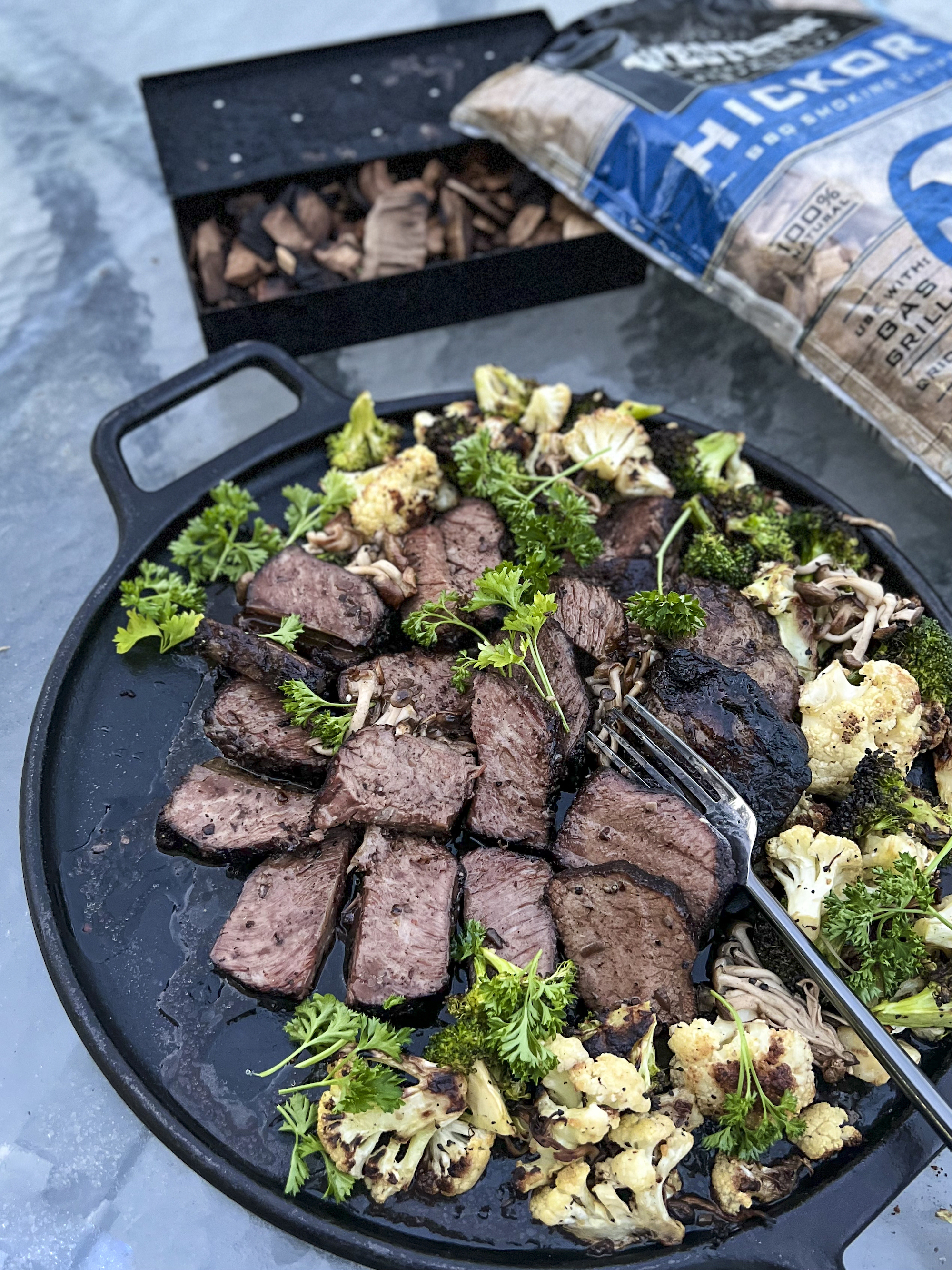 A cast iron platter of smoked beef short ribs ready to serve.