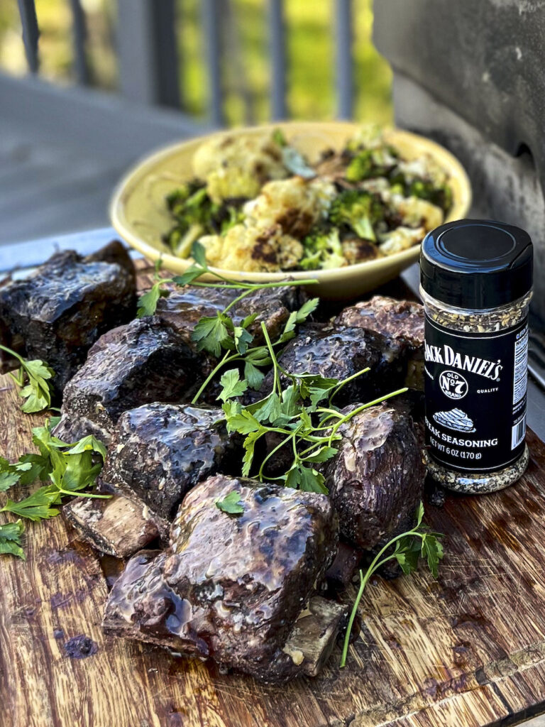 Smoked Ribs are ready to serve. Jack Daniel's Seasoning is in the photo to show the seasoning. 