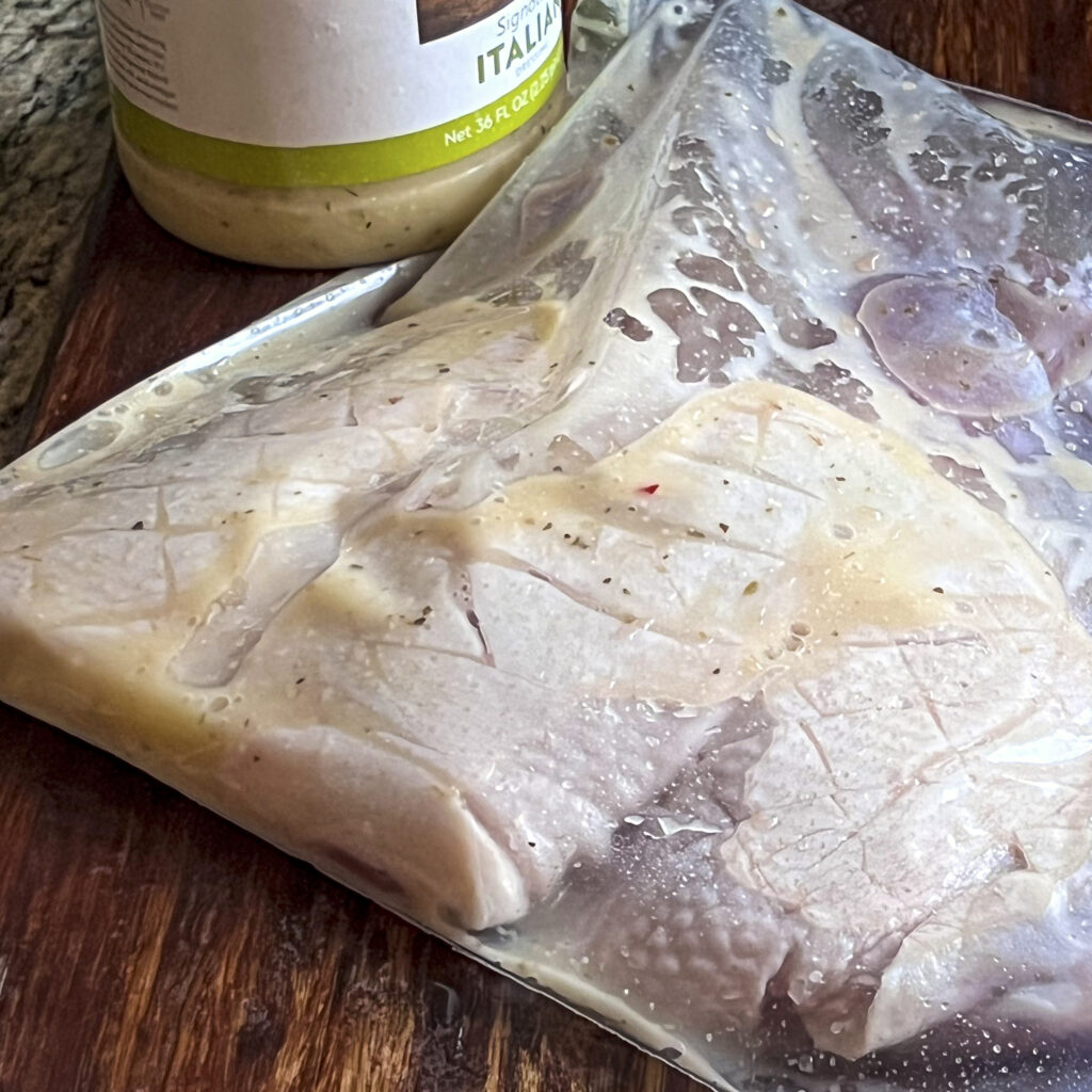 A ziplock baggy with 5 scored duck breasts and Italian dressing as the marinade. 
