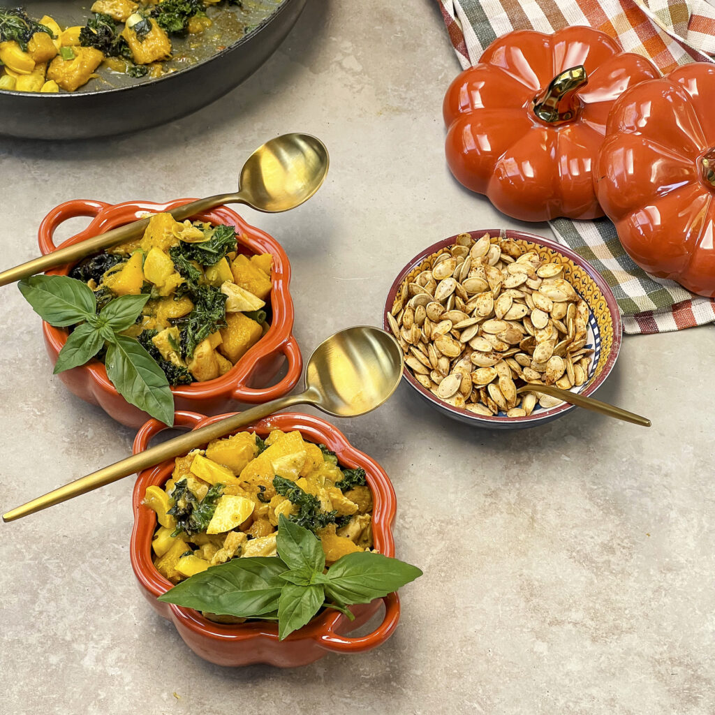 Two bowls of pumpkin, kale, andyellow squash vegetable medley. 