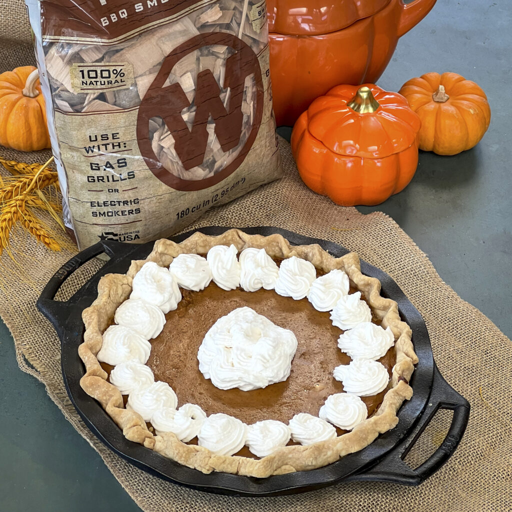Pumpkin Pie with whipped cream with a bag of maple smokin chips.
