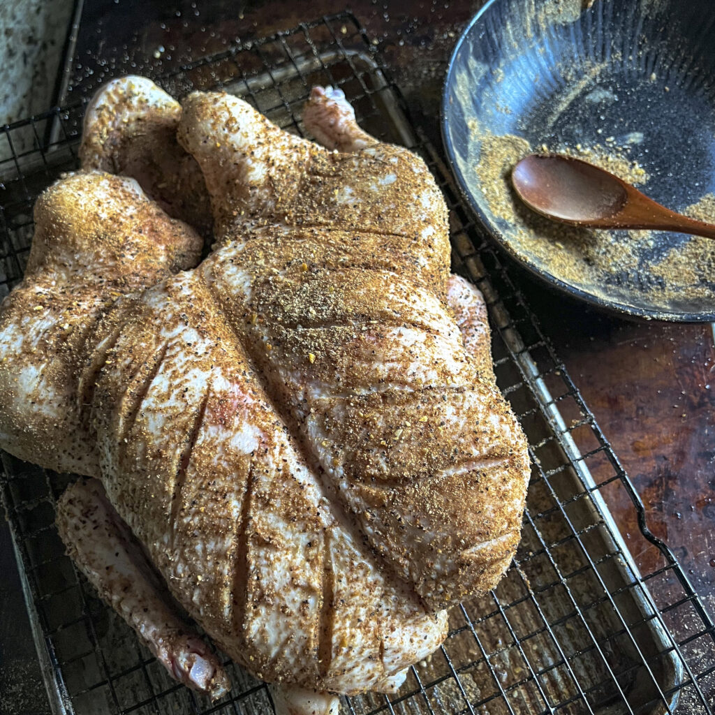A dry brine is rubbed on duck and it sits overnight. 