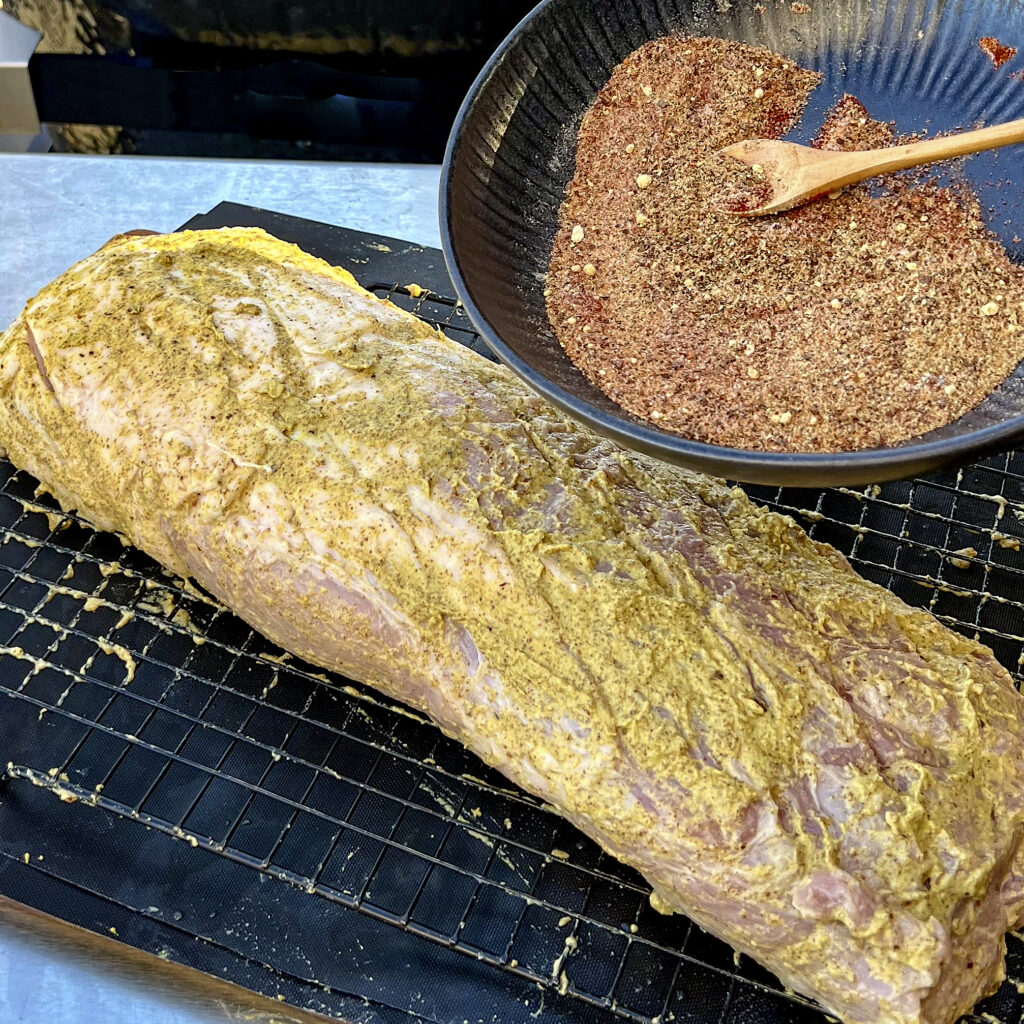 Rub mustard on all sides of the pork! 