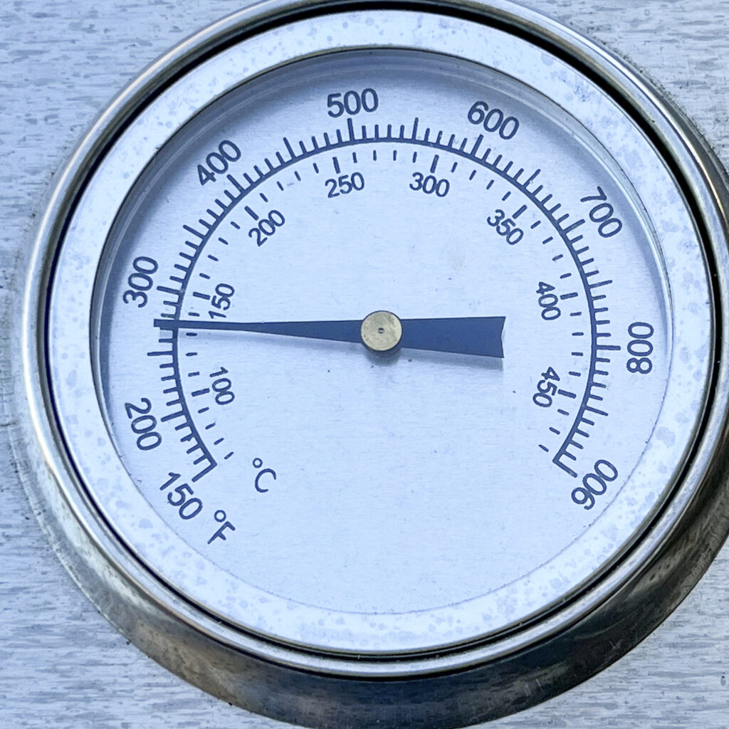 A grill thermometer reads 275°F.