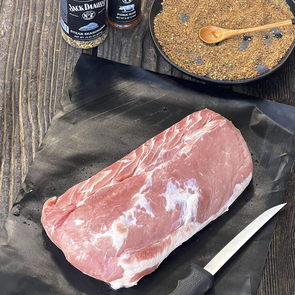 A raw pork loin is ready to be scored.