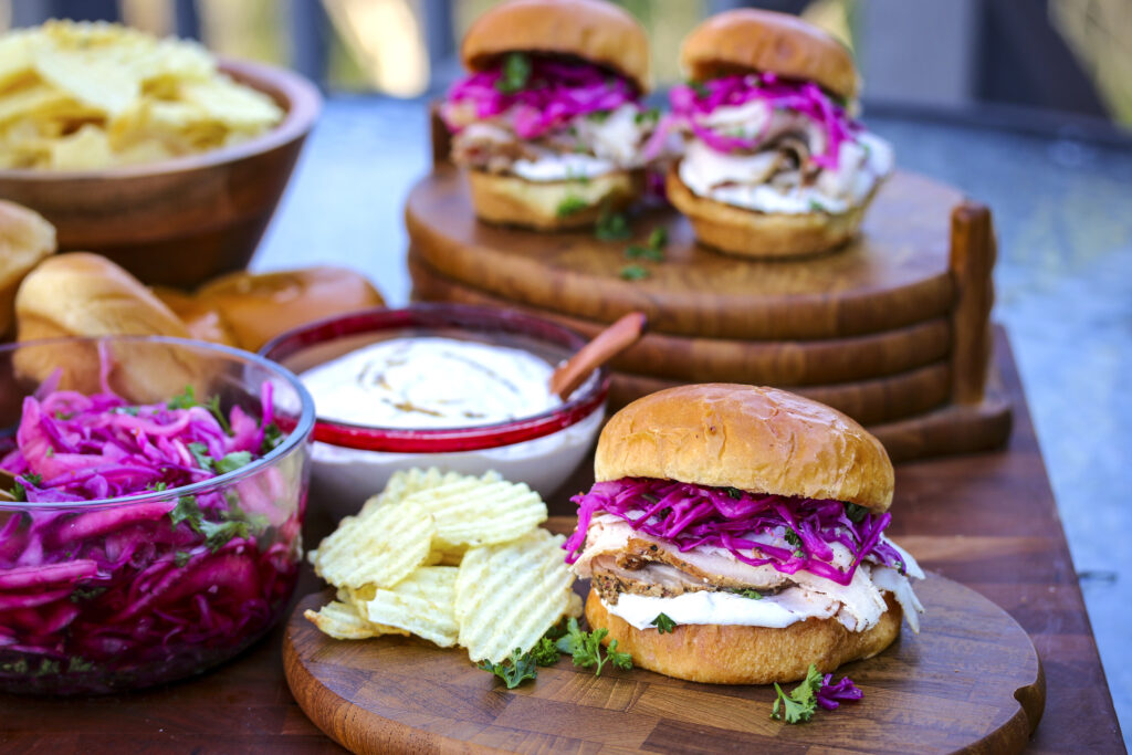 Smoked Pork Loin Sandwiches with pickled red cabbage and onions and a horseradish spread. 