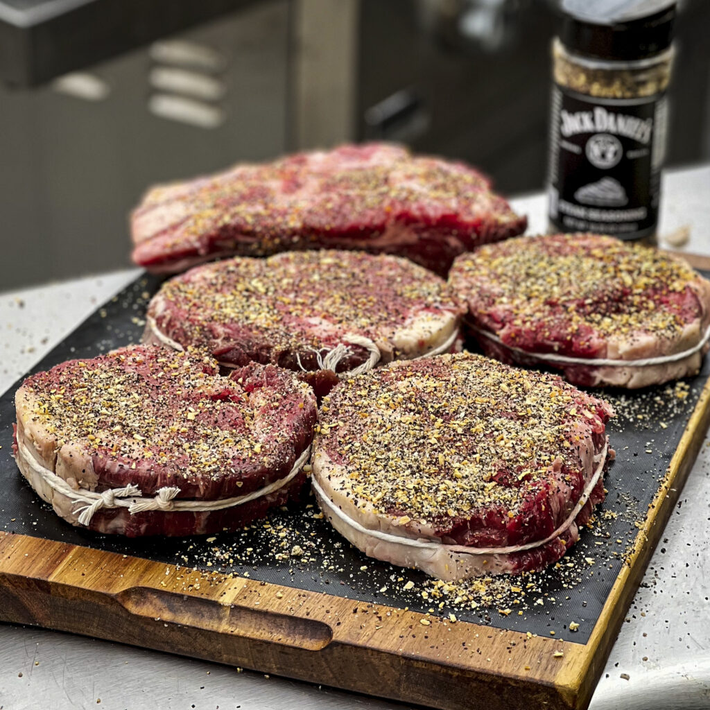 Steaks have been seasoned and tied, and are ready to grill. 