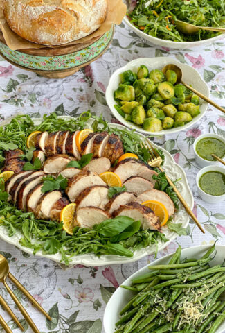 A Spring dinner with sliced smoked chicken breasts. Brussels Sprouts, green beans and salad.
