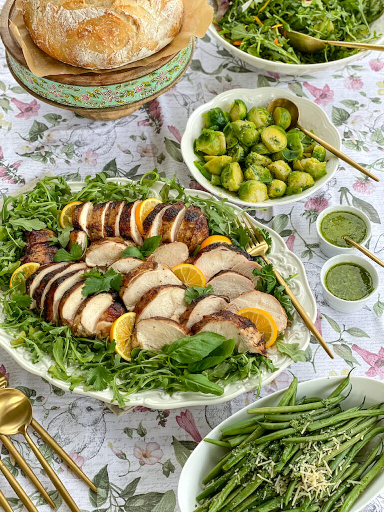 A Spring dinner with sliced smoked chicken breasts. Brussels Sprouts, green beans and salad.