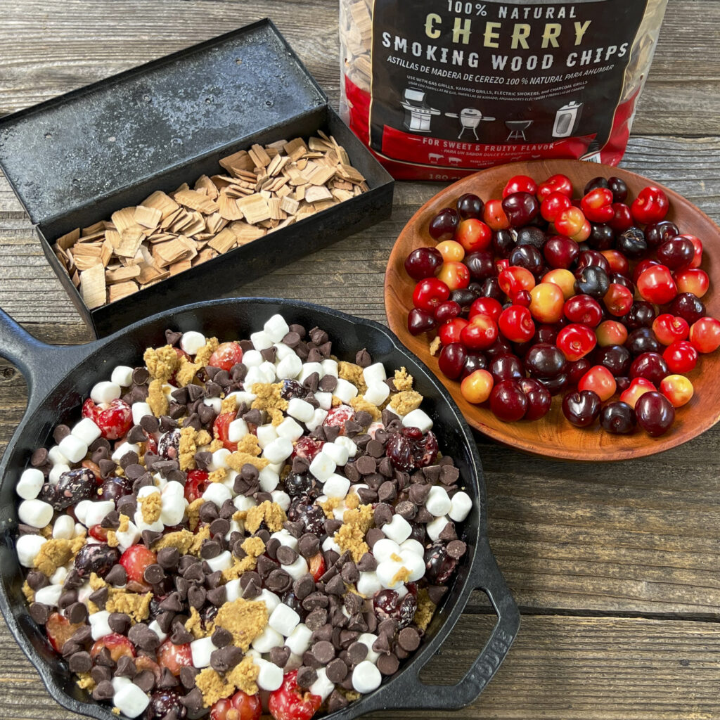 A skillet of Chocolate Cherry S'more Cookie Bars is about to be grilled. 