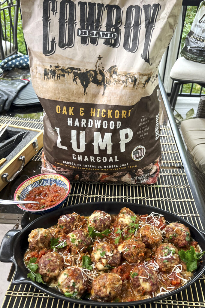 A bag of cowboy lump charcoal with a platter of SMOKED ITALIAN ALL BEEF MEATBALLS. 