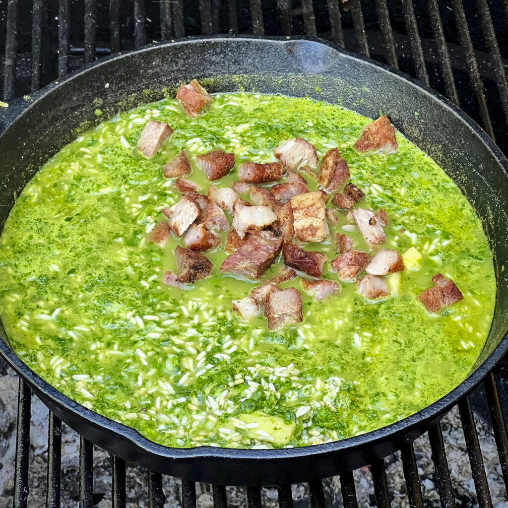 Smoked Pork is added to the rice at the same time the spinach puree is. 