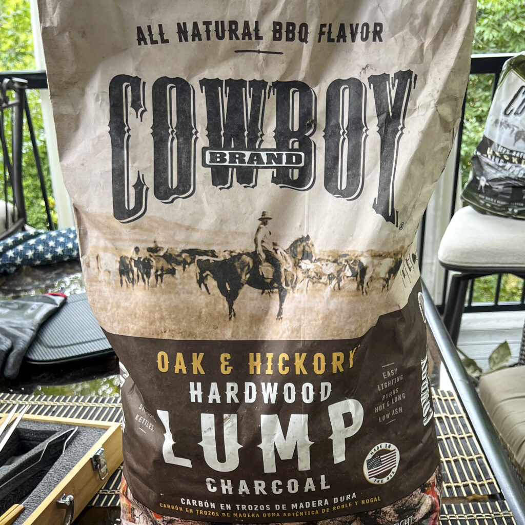 A bag of Cowboy Oak and Hickory Hardwood Lump Charcoal.