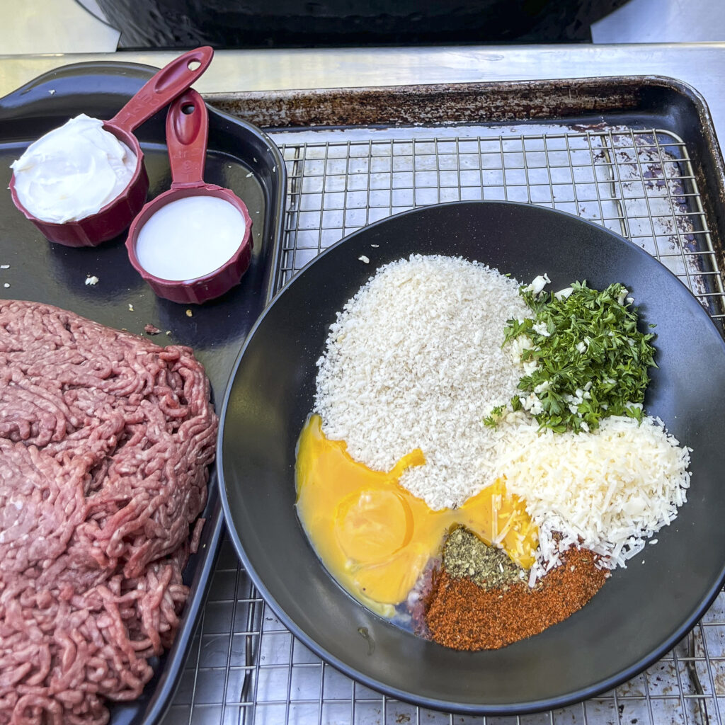 A bowl showing the spices and cheese that are mixed with panko crumbs. 