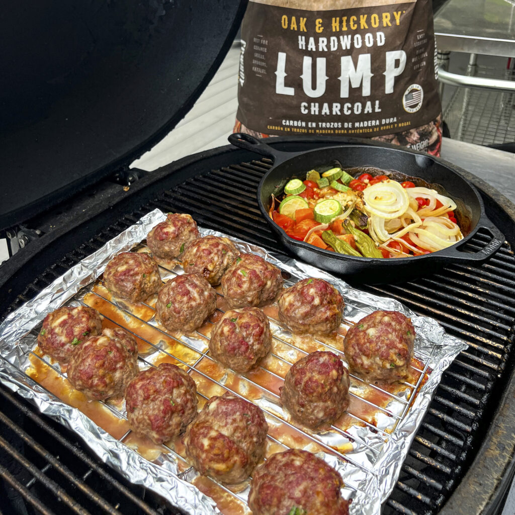 Oak & Hickory Smoked Italian All Beef Meatballs are on a rack on the grill. 