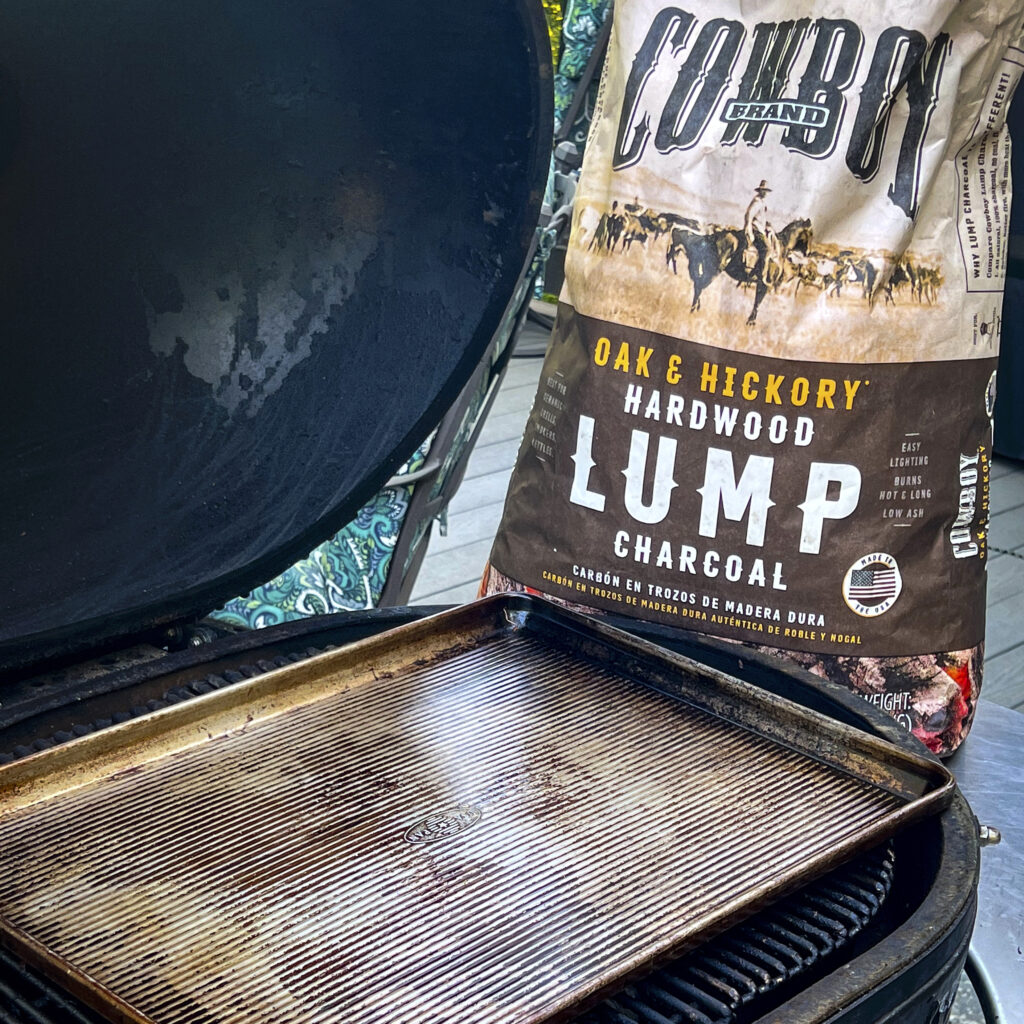 A sheet pan with a bag of Cowboy Lump Charcoal.