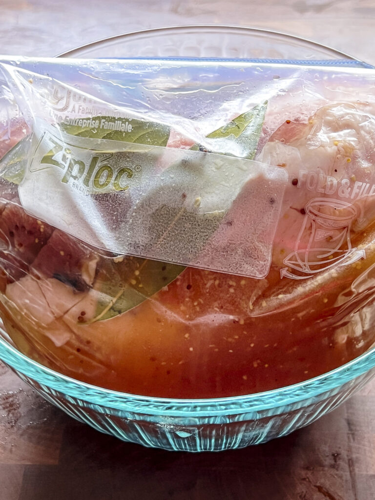 A plastic gallon bag holds the pork loin and the brine solution. 