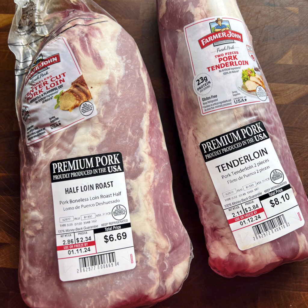 A pork loin in a package right next to a pork tenderloin. The two cuts of pork are quite different. 