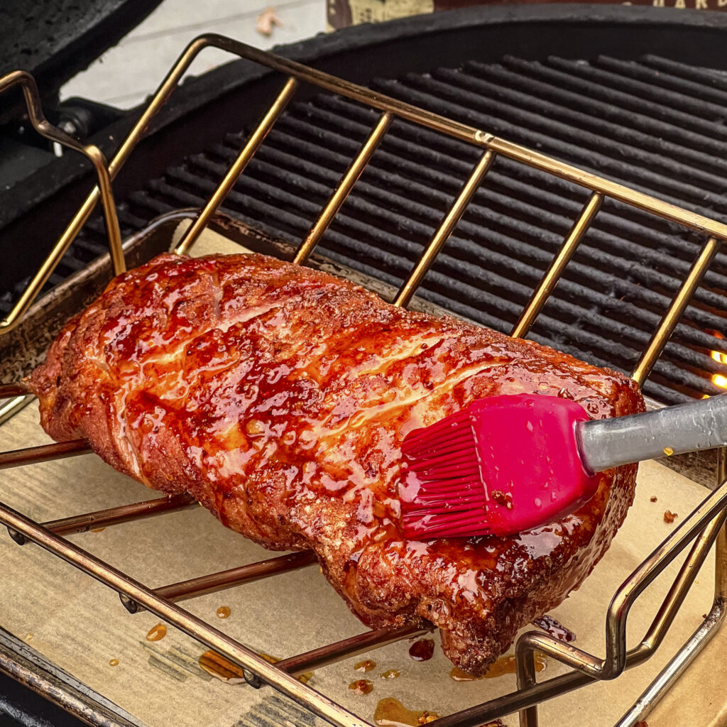 A spicy orange marmalade glaze is applied to smoked pork loin before charring over direct heat. 