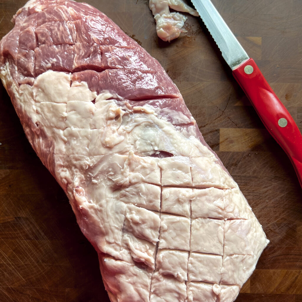 A pork loin that is showing how the fat can be scored. 