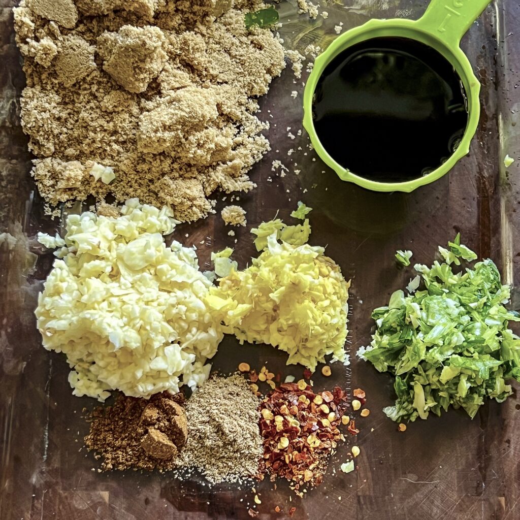 Ingredients are shown for lamb marinade: soy sauce, ginger, garlic, coriander, scallions, brown sugar and red pepper flakes.