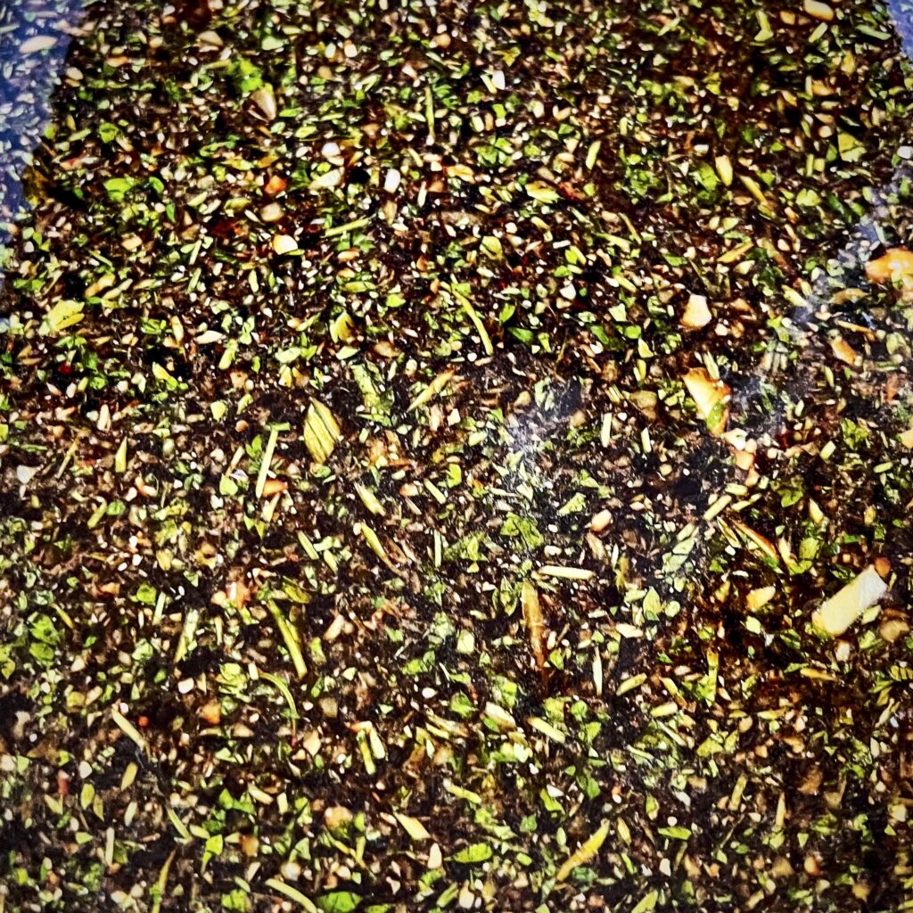 A close up of a soy sauce based brine with chives and cilantro. 