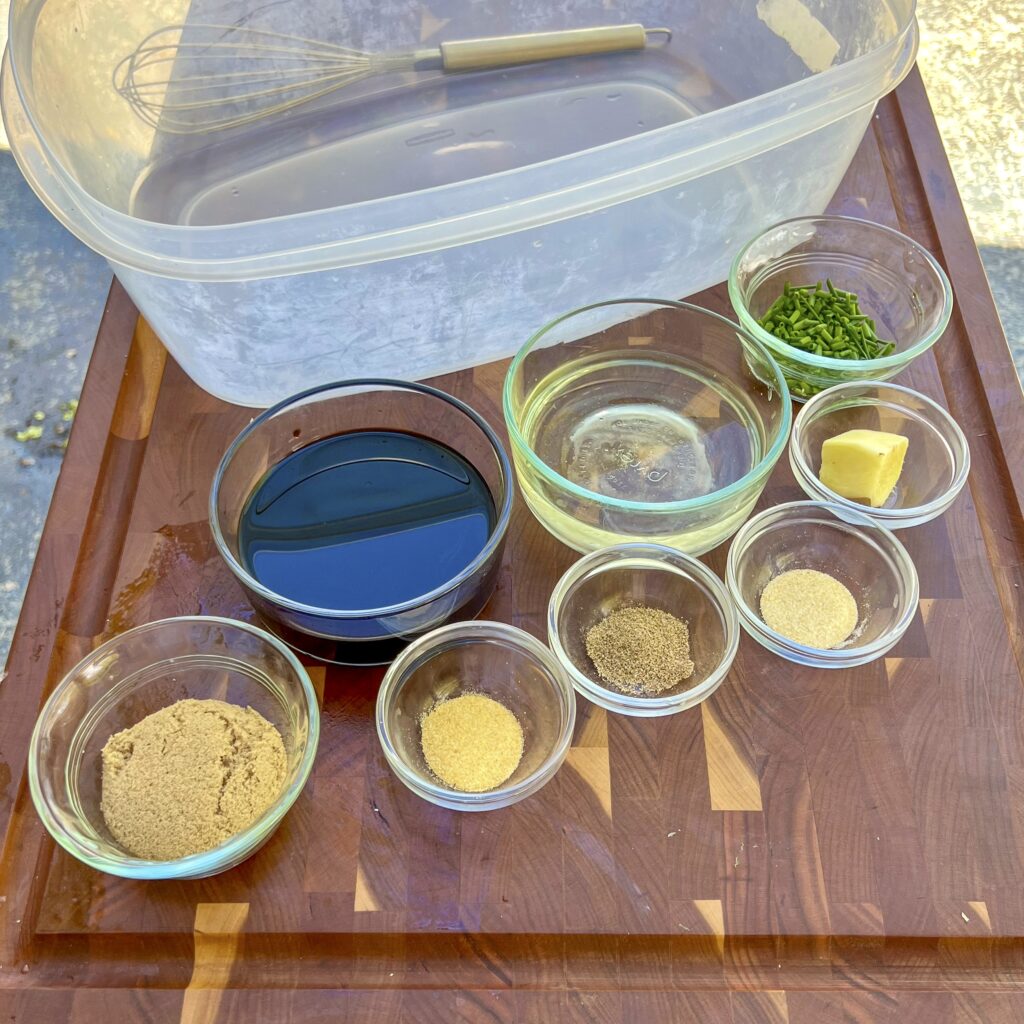 Brine ingredients for Smoked Trout in front of a large marination container. 