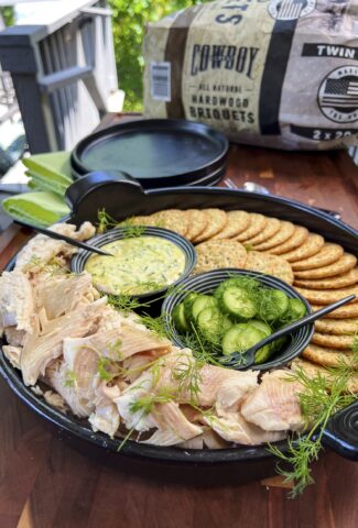 Smoked Trout is plated with mustard sauce and cucumbers with dill.